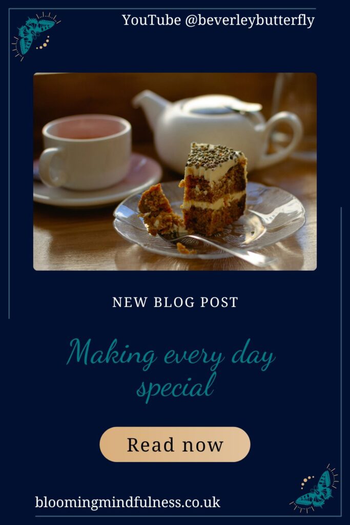 A small white teapot, a cup of tea and a slice of cake on a plate with a fork is seen on a table