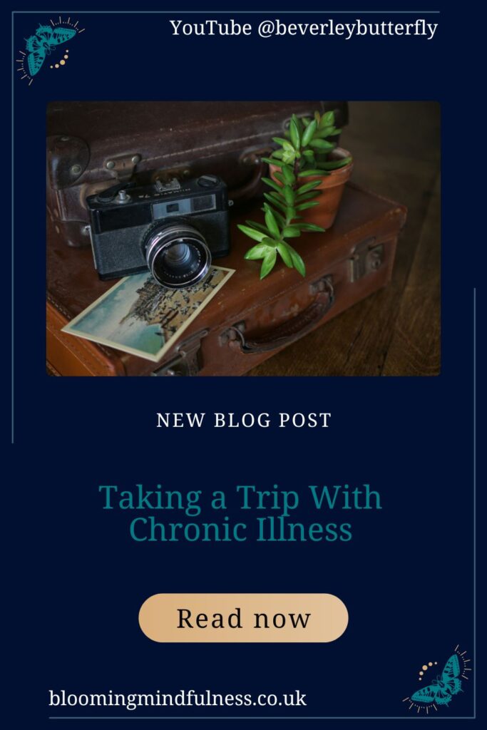 Vintage style luggage is seen on its side, with a vintage camera and a plant on top to represent taking a trip with chronic illness