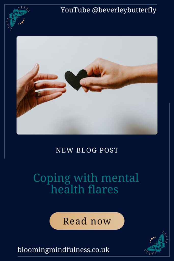 two hands are seen reaching out from either side of the picture. The one on the right is passing a small black heart this is against a white background. Represents Coping with mental health flares