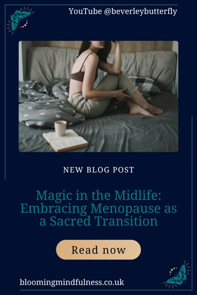 A woman in seen sitting on a bed, the bedding is grey and beside her is an open book with a mug of coffee on top 