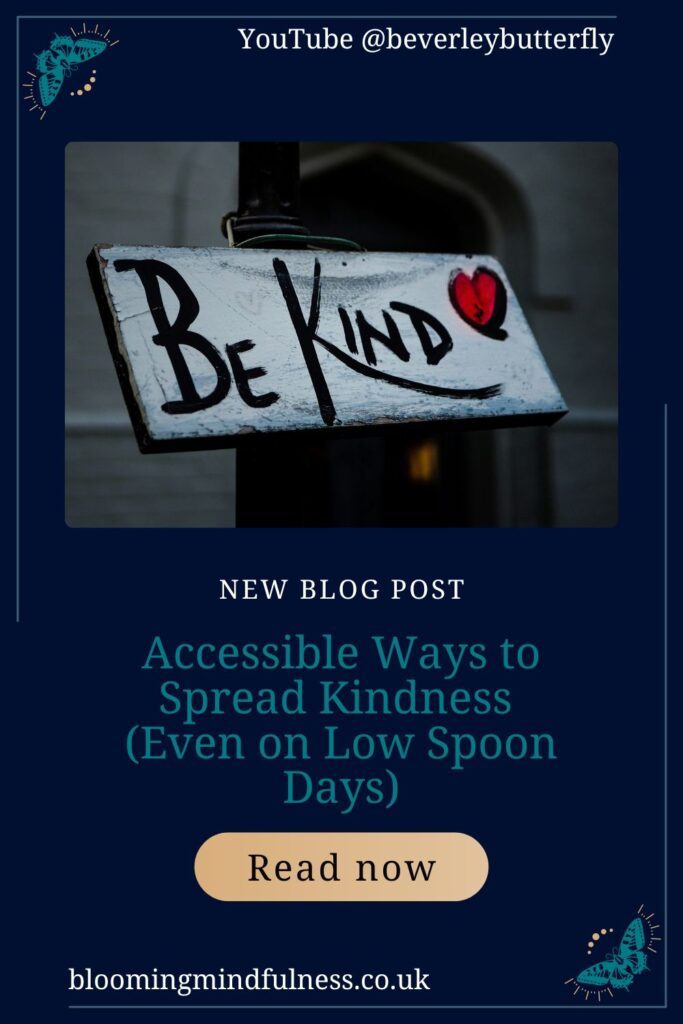 A sign is seen, painted white with a red heart and the writing Be Kind written in black to represent accessible ways to spread kindness