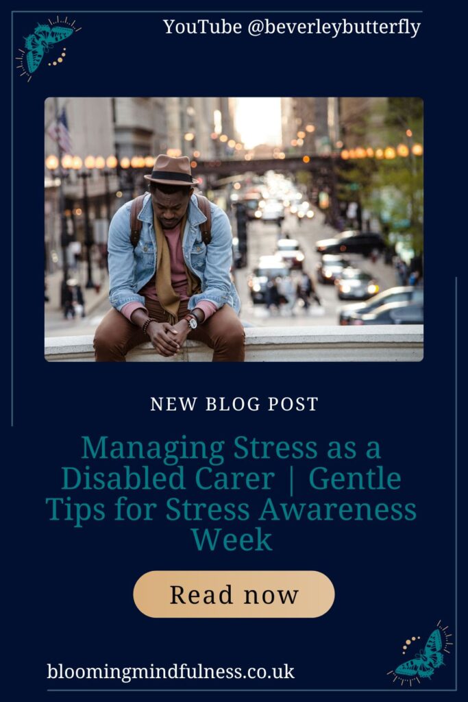 A man is sat on a low wall, behind him is a busy street, he is wearing a brown outfit under a blue denim jacket and a brown trilby on his head. He is looking down seemingly depressed and struggling to represent Managing Stress as a Disabled Carer 