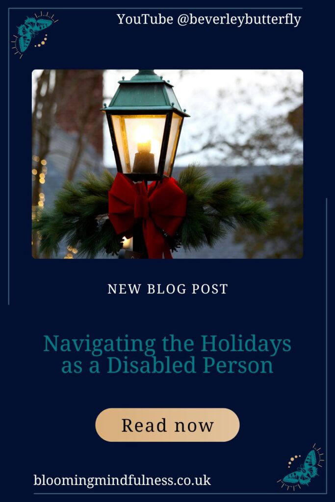 An old fashioned style lamppost is seen, close in on the lit part, below this section is tied a large red bow and fir brances, behind can be seen christmas lights out of focus to represent navigating the holidays as a disabled person
